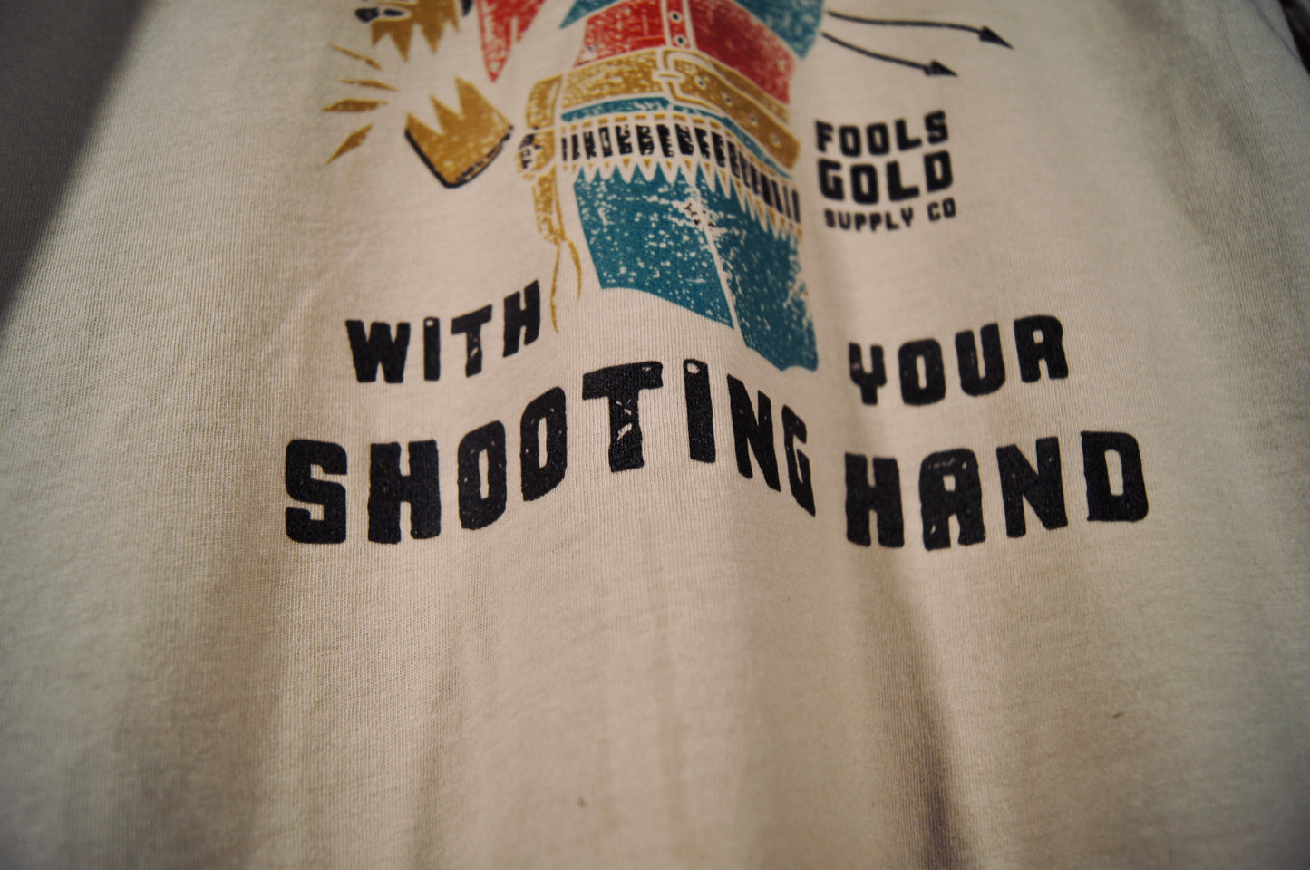 Never Drink With Your Shooting Hand T-Shirt - Front Graphic - Heather Dust
